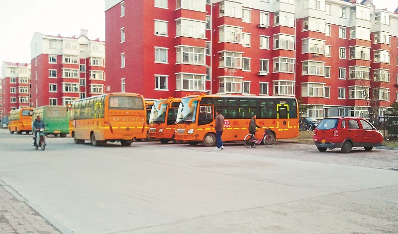 多輛校車停在黑輔導班樓前。