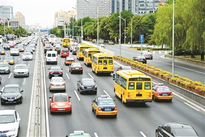 西二環(huán)主路，幾輛黃色校車列隊行駛供圖/CFP